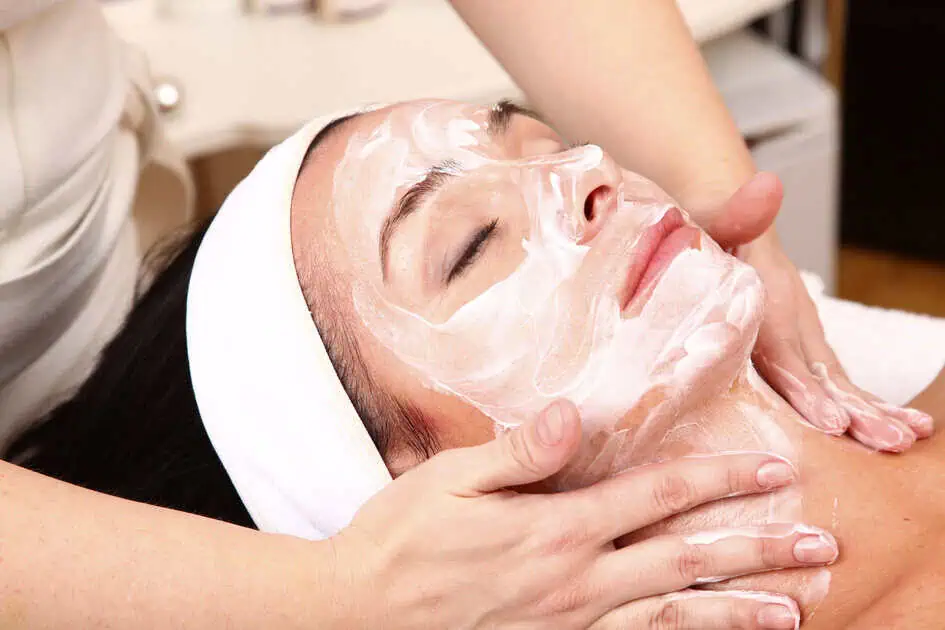 Teen receiving a professional facial treatment for hormonal acne to help reduce deep blind pimples and improve skin health.